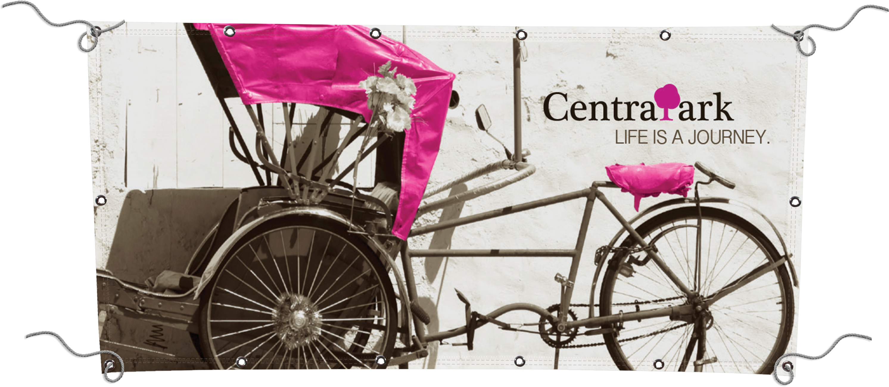 White vinyl banner with picture of pink rickshaw